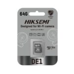 HIKSEMI DE1 64GB Class 10 V30 MicroSDXC memory card placed next to a smart home Wi-Fi security camera, highlighting continuous video storage.
