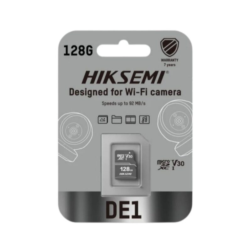 HIKSEMI DE1 128GB Class 10 V30 MicroSDXC memory card placed next to a smart home Wi-Fi security camera, highlighting continuous video storage.