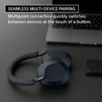 Sony WH-1000XM5 wireless over-ear noise-canceling headphones in silver, displayed with its matching compact protective carrying case.