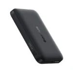 Baseus EnerFill FM11 10000mAh ultra-mini magnetic power bank snapped onto the back of a smartphone, showing its compact size and wireless charging capability.