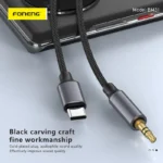 FONENG BM31 Type-C to 3.5mm metallic audio cable with braided cord connecting a Type-C smartphone to a 3.5mm headphone jack.