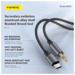 FONENG BM31 Type-C to 3.5mm metallic audio cable with braided cord connecting a Type-C smartphone to a 3.5mm headphone jack.